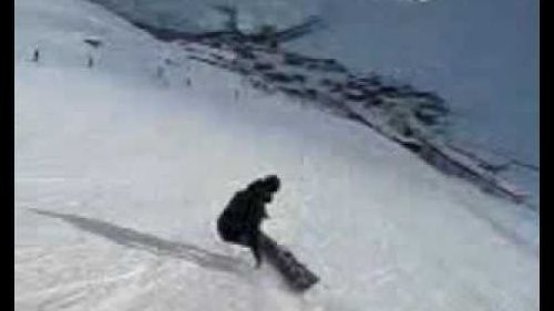 Dan falling over on a snowboard